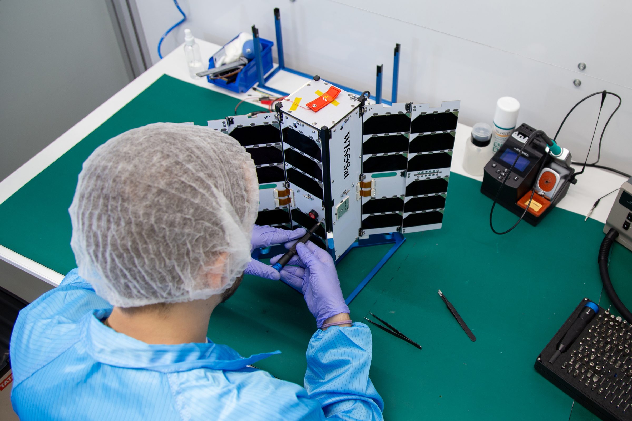 Engineer assembling a WISeSat satellite in the clean room