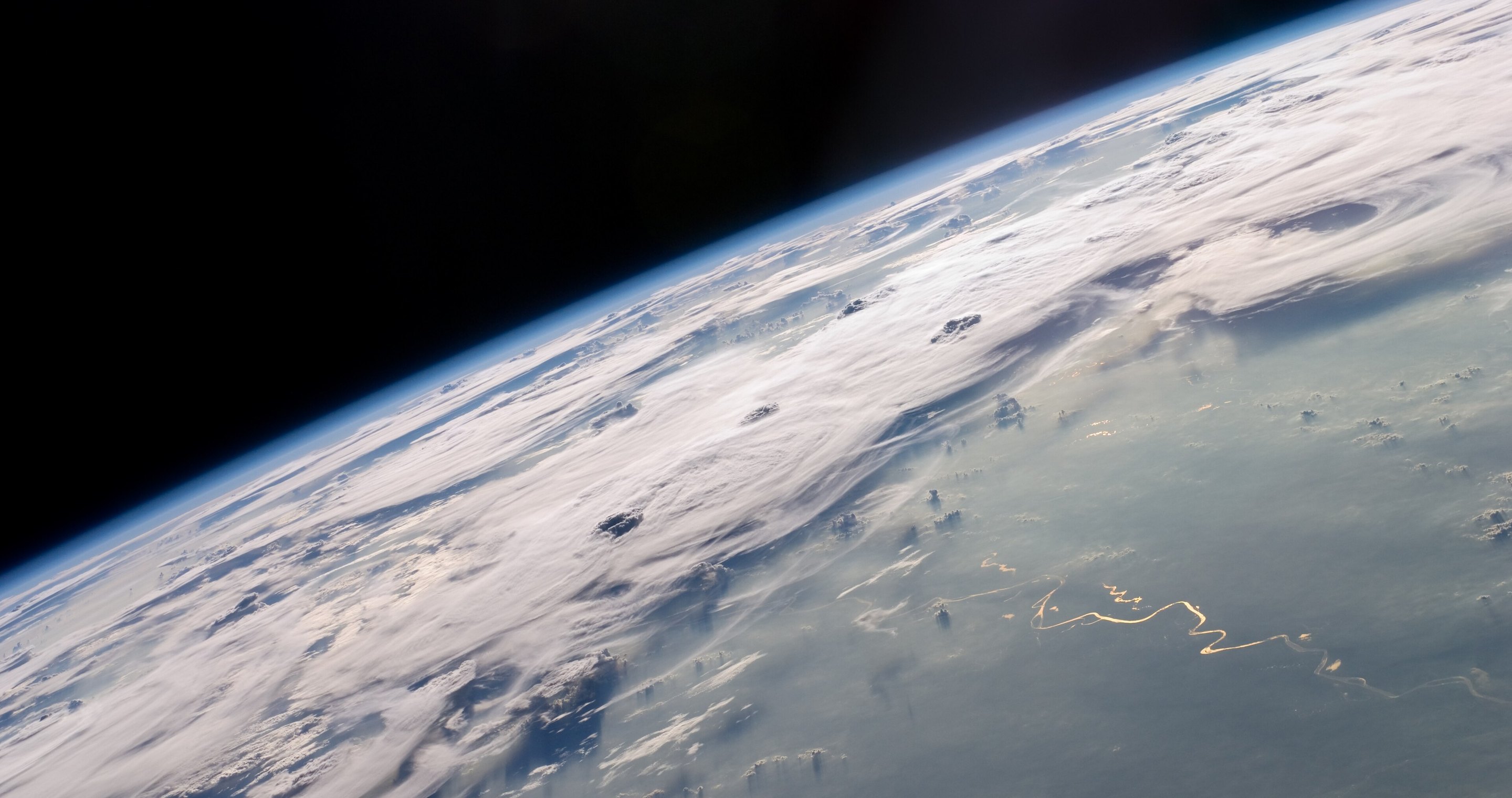 Earth's horizon over thunderstorms in Brazil, seen from the International Space Station (NASA)